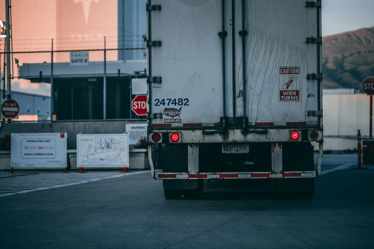 Rear view of a freight haulage truck entering a logistics facility