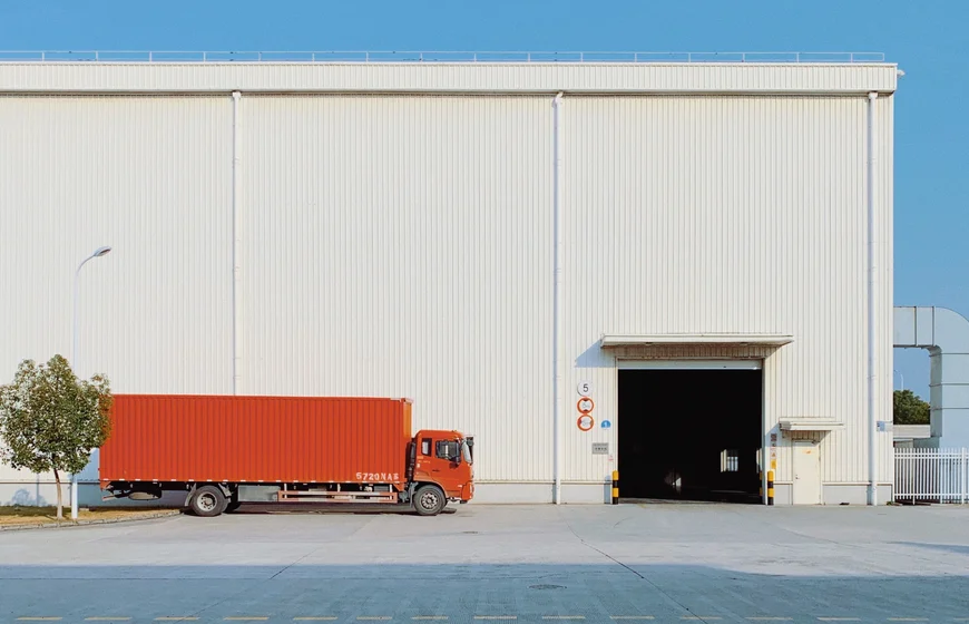 Red freight truck at loading dock representing shipment contract risk of loss