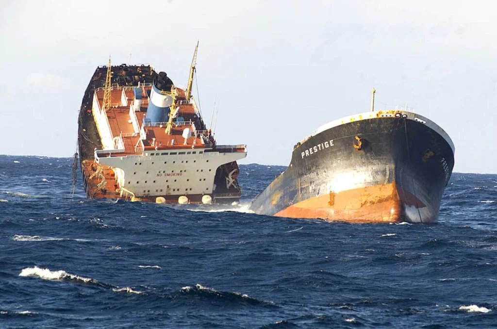 The Prestige oil tanker breaking apart in rough seas before sinking off the coast of Galicia in November 2002, leading to a major environmental disaster.