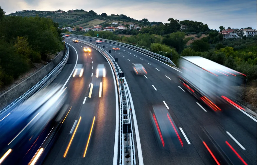 Fast-moving trucks on a highway representing subrogation recovery in cargo logistics